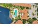 Aerial of community pool and clubhouse overlooking the lake with lush landscaping at 6121 Metrowest Blvd # 103, Orlando, FL 32835