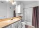 Neutral bathroom featuring a large mirror, shower/tub with a curtain, and a toilet at 6121 Metrowest Blvd # 103, Orlando, FL 32835