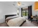 Relaxing bedroom offers a workspace, natural light, and a serene view at 6121 Metrowest Blvd # 103, Orlando, FL 32835