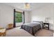 Cozy bedroom featuring carpet, neutral paint, large window view, and a ceiling fan at 6121 Metrowest Blvd # 103, Orlando, FL 32835