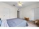 Neutral bedroom with large closets, carpet, a ceiling fan, and an open door to another room at 6121 Metrowest Blvd # 103, Orlando, FL 32835