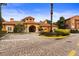 Elegant clubhouse entrance with manicured landscaping and decorative brick pavers at 6121 Metrowest Blvd # 103, Orlando, FL 32835