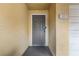Entryway view of a neutral door featuring a peephole, lock and handle, and house number at 6121 Metrowest Blvd # 103, Orlando, FL 32835