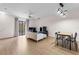 Bright living room featuring wood floors, a ceiling fan and a window for natural light at 6121 Metrowest Blvd # 103, Orlando, FL 32835