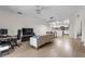 Open concept living room with wood flooring, modern lighting, and easy access to the kitchen at 6121 Metrowest Blvd # 103, Orlando, FL 32835