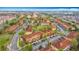 Aerial view of a community with well-maintained townhomes, terracotta roofs, and lush green landscaping at 2634 Andros Ln, Kissimmee, FL 34747