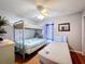Bedroom featuring bunkbeds and a single bed, all bathed in natural light from a window at 2634 Andros Ln, Kissimmee, FL 34747