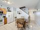 Cozy kitchen featuring tile floors, white appliances, light wood cabinets, and a charming breakfast nook at 2634 Andros Ln, Kissimmee, FL 34747