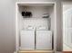 A laundry closet with a washer, dryer, and wire shelving for storage at 2634 Andros Ln, Kissimmee, FL 34747