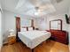 Main bedroom featuring a tray ceiling, wood floors, and ample natural light at 2634 Andros Ln, Kissimmee, FL 34747
