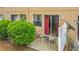 Private patio with sliding glass door, lush greenery, and a cozy seating area at 2634 Andros Ln, Kissimmee, FL 34747