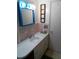Bathroom with a vanity, mirror with vanity lighting and pink tile at 3695 Dale Ct, Mount Dora, FL 32757