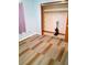 Bedroom featuring wood-look flooring, a closet, and blue painted walls at 3695 Dale Ct, Mount Dora, FL 32757