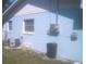 Exterior view of a light blue home showcasing the A/C unit and electrical box at 3695 Dale Ct, Mount Dora, FL 32757