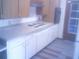 A kitchen featuring ample counter space, white cabinets, and a four-burner cooktop at 3695 Dale Ct, Mount Dora, FL 32757