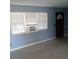 Comfortable room with a window, a dark color door and an A/C unit, offering a cozy space to relax at 3695 Dale Ct, Mount Dora, FL 32757