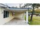 Covered carport providing shelter and convenience adjacent to the side of the house at 101 Ellison Ave, New Smyrna Beach, FL 32168
