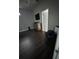 Bedroom showcasing dark wood floors, complemented by neutral walls, a wooden dresser and a TV at 2822 Seymore St, Lakeland, FL 33813