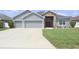 Charming one-story home featuring gray siding and a spacious driveway at 2822 Seymore St, Lakeland, FL 33813