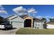 Charming single-story home with gray siding, stone accents, and a well-manicured lawn at 2822 Seymore St, Lakeland, FL 33813