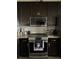 Modern kitchen with dark cabinets and stainless steel appliances, including a sleek range at 2822 Seymore St, Lakeland, FL 33813