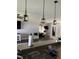 Open floor plan with lighting pendants over the breakfast bar and access to the living room at 2822 Seymore St, Lakeland, FL 33813