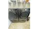 Laundry room features a gray front loading washer and dryer, and storage shelving above at 2822 Seymore St, Lakeland, FL 33813