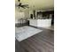 Open floor plan with living room, kitchen with breakfast bar, ceiling fans and dark wood floors at 2822 Seymore St, Lakeland, FL 33813
