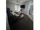 Living room features a sectional sofa, ceiling fan, a television, and access to other areas of the home at 2822 Seymore St, Lakeland, FL 33813