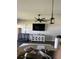 Open floor plan with lighting pendants over the breakfast bar and access to the living room with a television at 2822 Seymore St, Lakeland, FL 33813