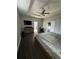 Main bedroom features a ceiling fan, a television, and a door to the bathroom and walk-in closet at 2822 Seymore St, Lakeland, FL 33813
