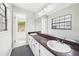 Bathroom with double sink vanity, large mirror, and natural light from the window at 1776 E Cheryl Dr, Winter Park, FL 32792