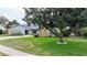 Charming single-story home featuring stone accents, a well-manicured lawn, and mature landscaping at 1776 E Cheryl Dr, Winter Park, FL 32792