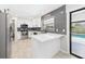 Modern kitchen with white cabinets, stainless steel appliances, and a view to the pool at 1776 E Cheryl Dr, Winter Park, FL 32792
