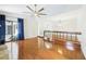 Bright living room featuring shiny wood floors, ceiling fan, sliding glass doors, and open layout to hallway at 1776 E Cheryl Dr, Winter Park, FL 32792