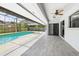Screened-in outdoor pool area with tile flooring and a ceiling fan for added comfort at 1776 E Cheryl Dr, Winter Park, FL 32792