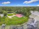Lakeside home with a manicured lawn, access to the lake, surrounded by trees, and features a private dock at 318 Mitnik Dr, Deltona, FL 32738