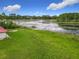 Aerial view of the expansive backyard, showcasing the lake and lush greenery at 318 Mitnik Dr, Deltona, FL 32738