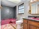 Bathroom featuring pink tub and sink and oak vanity at 318 Mitnik Dr, Deltona, FL 32738