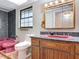 Bathroom featuring an oak vanity and pink sink and tile at 318 Mitnik Dr, Deltona, FL 32738