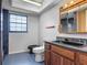 This bathroom features granite countertops, dark wood cabinetry, and a unique black sink and toilet at 318 Mitnik Dr, Deltona, FL 32738