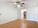 Inviting bedroom with wood-look flooring, bright walls, and ample space, leading to an adjoining bathroom at 318 Mitnik Dr, Deltona, FL 32738