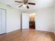 This spacious bedroom has wood floors and a convenient door to the en-suite bathroom at 318 Mitnik Dr, Deltona, FL 32738