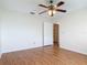 A bedroom with ceiling fan, wood-look floors and an open closet at 318 Mitnik Dr, Deltona, FL 32738