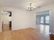 Open dining area with hardwood floors and view into living area and updated kitchen at 318 Mitnik Dr, Deltona, FL 32738