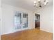 Bright dining room featuring wood floors, classic chandelier, and view into the kitchen at 318 Mitnik Dr, Deltona, FL 32738