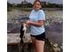 Personal holding a large fish caught on the lake, standing on the wooden dock at 318 Mitnik Dr, Deltona, FL 32738