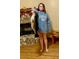 Personal holding a huge bass inside a home decorated with a stone fireplace and fall decor at 318 Mitnik Dr, Deltona, FL 32738