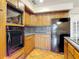 Kitchen featuring modern appliances, wood cabinets, and granite countertops at 318 Mitnik Dr, Deltona, FL 32738