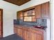 Outdoor kitchen featuring wood cabinets, granite counters, a sink, and a window opening at 318 Mitnik Dr, Deltona, FL 32738